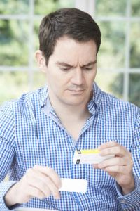 man checking packet of sildenafil