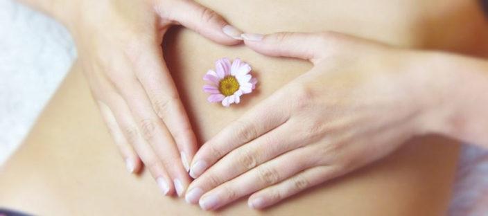 Woman with flower on stomach to symbolise her period