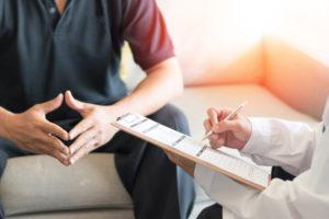 Photo of man in sexual health clinic with doctor